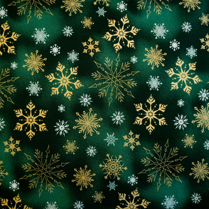 Baumwolle goldene Schneeflocken auf grün